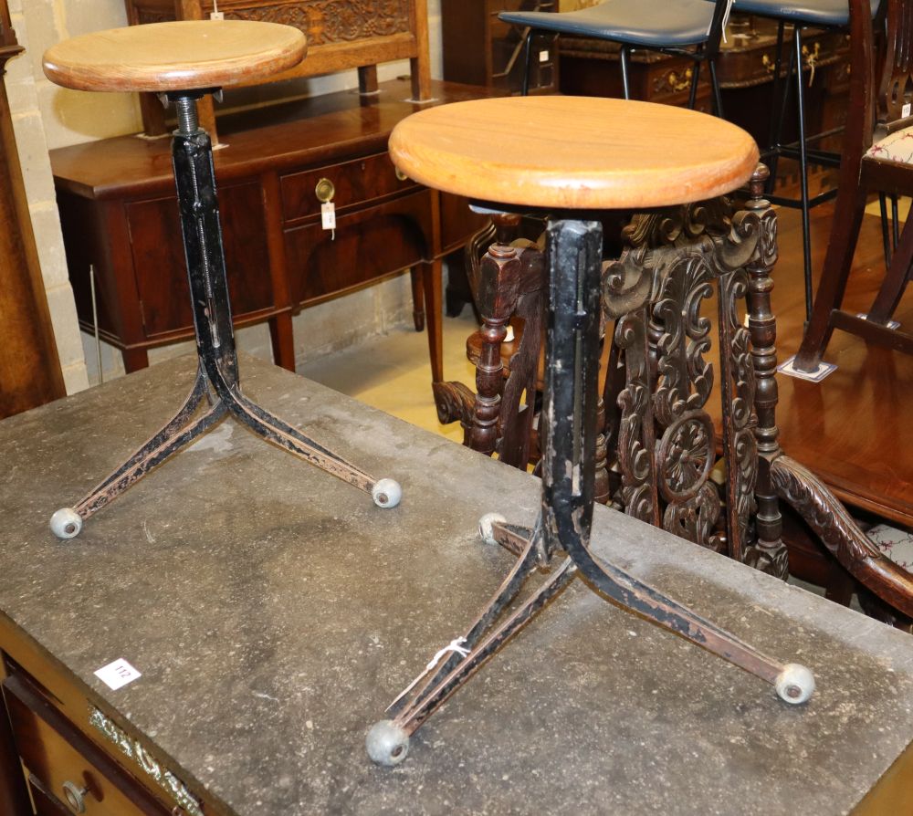A pair of mid century design oak and wrought iron adjustable typists stools, seat diameter 30cm